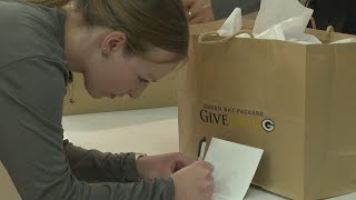 Packers staff assembles care packages for veterans plays bingo with residents at Woodside Senior Co [upl. by Allemap]