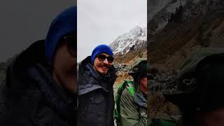 Two men are hiking in mountains at cold snowy autumn day and filming vlog [upl. by Anirak]